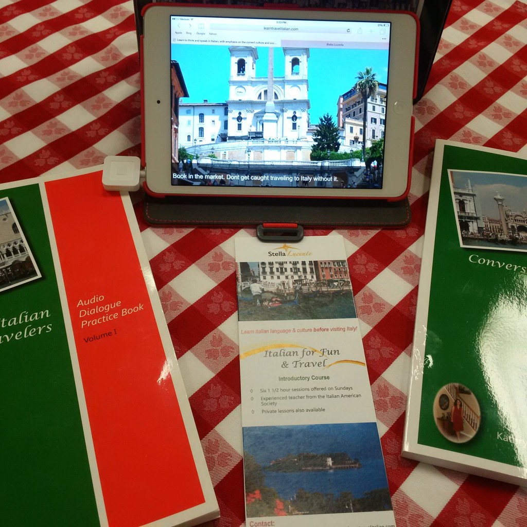 Conversational Italian for travelers books and website on an ipad on a red checkered table cloth