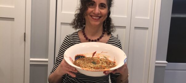 Food blogger Kathryn Occhipinti holding a bowl of lentil soup